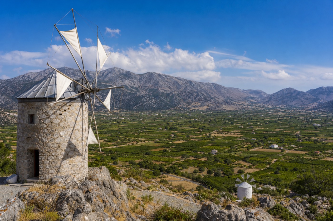 Stone windmills and green fields on the Lasithi Plateau, Crete